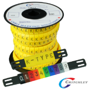 A reel of crtichley K-Type markers, with a carrier strip of different coloured slide on markers 